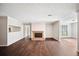 Bright living room with hardwood floors, brick fireplace, neutral paint, and large windows at 5555 Mountain Springs Cir, Stone Mountain, GA 30088