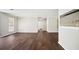 Open-concept living room featuring hardwood floors, crown molding, and view into the kitchen at 5555 Mountain Springs Cir, Stone Mountain, GA 30088