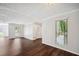 Bright living space showcasing hardwood floors, large windows, and neutral paint with white trim at 5555 Mountain Springs Cir, Stone Mountain, GA 30088