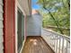 Private balcony featuring wood flooring, white railings, and red shutters providing a peaceful outdoor retreat at 219 Cobblestone Trl, Avondale Estates, GA 30002