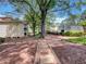 Community grounds and walkways with mature trees, well-maintained landscaping and community tennis court at 219 Cobblestone Trl, Avondale Estates, GA 30002