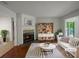 Cozy living room featuring a fireplace, bright decor and hardwood floors at 219 Cobblestone Trl, Avondale Estates, GA 30002