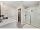 Bright bathroom featuring a glass-enclosed shower, neutral tones, and modern fixtures at 3610 Silvery Way, Powder Springs, GA 30127