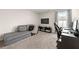 Comfortable bedroom features a sofa, large TV, and workspace at 3610 Silvery Way, Powder Springs, GA 30127