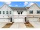 Charming townhouse showcasing a brick facade, attached garage, and well-manicured lawn at 3610 Silvery Way, Powder Springs, GA 30127