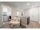 Upstairs hallway featuring a cozy chair with access to the laundry room and bedroom areas at 3610 Silvery Way, Powder Springs, GA 30127