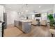 Open-concept kitchen with a large island, stainless steel appliances, and hardwood floors at 3610 Silvery Way, Powder Springs, GA 30127