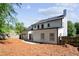 A spacious backyard with pine straw, and a bright white exterior at 4168 Arapaho Dr, Powder Springs, GA 30127