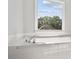 Bright bathroom featuring a white tub and chrome hardware at 4168 Arapaho Dr, Powder Springs, GA 30127