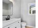 Bathroom featuring black hardware, white vanity and framed mirror at 4168 Arapaho Dr, Powder Springs, GA 30127