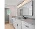Bathroom featuring granite counters, black hardware and bright lighting at 4168 Arapaho Dr, Powder Springs, GA 30127