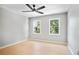 Bedroom featuring two windows, light colored wood floors and a ceiling fan at 4168 Arapaho Dr, Powder Springs, GA 30127