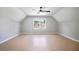 Bright bedroom features a modern ceiling fan, hardwood floors, and natural light from the window at 4168 Arapaho Dr, Powder Springs, GA 30127