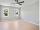 Bedroom features three windows, light colored wood floors and a ceiling fan at 4168 Arapaho Dr, Powder Springs, GA 30127