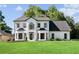 A charming home featuring a manicured lawn and striking black and white color scheme at 4168 Arapaho Dr, Powder Springs, GA 30127