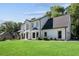 A two-story white home with black trim, landscaping, and a well-manicured lawn at 4168 Arapaho Dr, Powder Springs, GA 30127