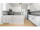 Modern kitchen features white cabinetry, stainless appliances, and granite countertops at 4168 Arapaho Dr, Powder Springs, GA 30127