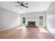 Bright living room with a cozy fireplace and a modern ceiling fan at 4168 Arapaho Dr, Powder Springs, GA 30127