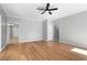 Spacious living room with archway to the stairs and gleaming wood floors at 4168 Arapaho Dr, Powder Springs, GA 30127