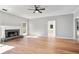 Open-concept living room with fireplace, modern fan, and ample natural light at 4168 Arapaho Dr, Powder Springs, GA 30127