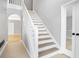 A naturally lit foyer with a stairway and stylish accents at 4168 Arapaho Dr, Powder Springs, GA 30127
