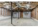 Unfinished basement area featuring gray garage doors and exposed ceiling at 42 Breckenridge Dr, Powder Springs, GA 30127