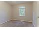 Neutral bedroom with a window and carpeted floors at 42 Breckenridge Dr, Powder Springs, GA 30127