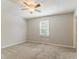 Neutral bedroom with carpeted floors, ceiling fan, and a window at 42 Breckenridge Dr, Powder Springs, GA 30127