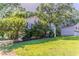Quaint home with a beautiful front yard, mature trees, and detached garage in the background at 42 Breckenridge Dr, Powder Springs, GA 30127