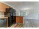 Open-concept kitchen with adjacent living area, featuring wooden cabinets and modern appliances at 42 Breckenridge Dr, Powder Springs, GA 30127