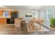 Kitchen with wood cabinets, black appliances, bar seating, and a dining table in a staged setting at 42 Breckenridge Dr, Powder Springs, GA 30127