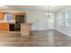Bright kitchen adjoins dining area with wooden cabinets, black appliances, and stylish flooring at 42 Breckenridge Dr, Powder Springs, GA 30127