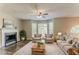 Staged living room features a fireplace, large windows, and neutral tones at 42 Breckenridge Dr, Powder Springs, GA 30127