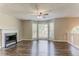 Bright living room with fireplace, hardwood floors and a large window area for natural light at 42 Breckenridge Dr, Powder Springs, GA 30127
