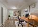 Staged living area featuring a desk, built-in bookshelf, and wood-look flooring at 42 Breckenridge Dr, Powder Springs, GA 30127
