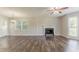 Spacious living room with hardwood floors, fireplace, and natural light from the windows at 42 Breckenridge Dr, Powder Springs, GA 30127