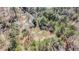 Drone shot showcasing the home nestled among trees and bordering woodlands for ultimate privacy at 522 Stell Rd, Woodstock, GA 30188