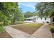 Spacious backyard featuring a concrete patio, lush lawn, and screened-in porch at 522 Stell Rd, Woodstock, GA 30188