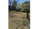 Partially cleared backyard with trees and a small grassy area at 522 Stell Rd, Woodstock, GA 30188