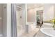 Bathroom with shower and tub combo and double sinks, plus bright natural light at 522 Stell Rd, Woodstock, GA 30188