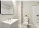 Compact bathroom featuring modern fixtures and a sleek vanity with storage space at 522 Stell Rd, Woodstock, GA 30188