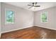 Empty bedroom featuring hardwood floors, neutral walls, and bright windows at 522 Stell Rd, Woodstock, GA 30188