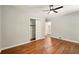 Bedroom features hardwood floors, ceiling fan, and sliding closet doors at 522 Stell Rd, Woodstock, GA 30188