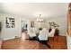 Bright dining room with a modern light fixture, hardwood floors and seating for six at 522 Stell Rd, Woodstock, GA 30188