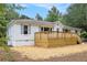 Charming single-story home boasts a new wood deck and light blue shutters at 522 Stell Rd, Woodstock, GA 30188