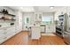 Bright kitchen features custom white cabinets, stainless steel appliances, and a convenient breakfast bar at 522 Stell Rd, Woodstock, GA 30188