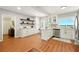 Spacious kitchen with white cabinets, stainless appliances, open shelves, and a breakfast bar for easy dining at 522 Stell Rd, Woodstock, GA 30188