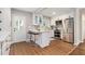 Modern kitchen with white cabinets, stainless steel appliances, and breakfast bar seating at 522 Stell Rd, Woodstock, GA 30188