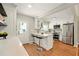 Bright kitchen with stainless steel appliances, white cabinets, and a breakfast bar with seating at 522 Stell Rd, Woodstock, GA 30188