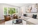 Cozy living room with a large window overlooking lush greenery and comfortable seating at 522 Stell Rd, Woodstock, GA 30188